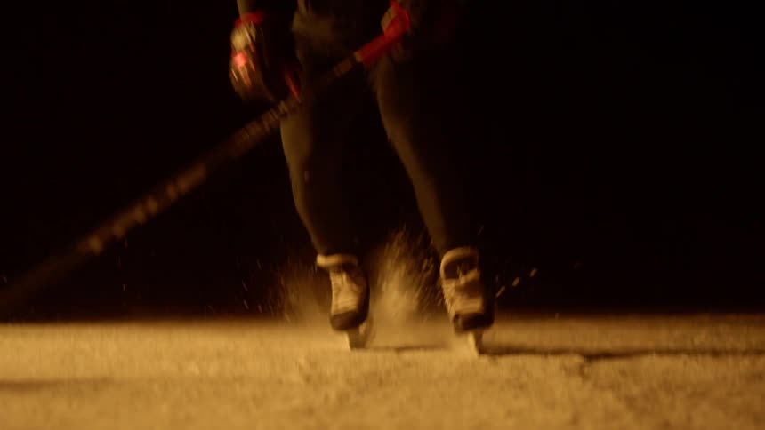 Man plays hockey on ice