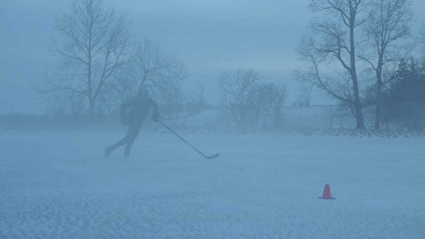 Man plays hockey in the fog