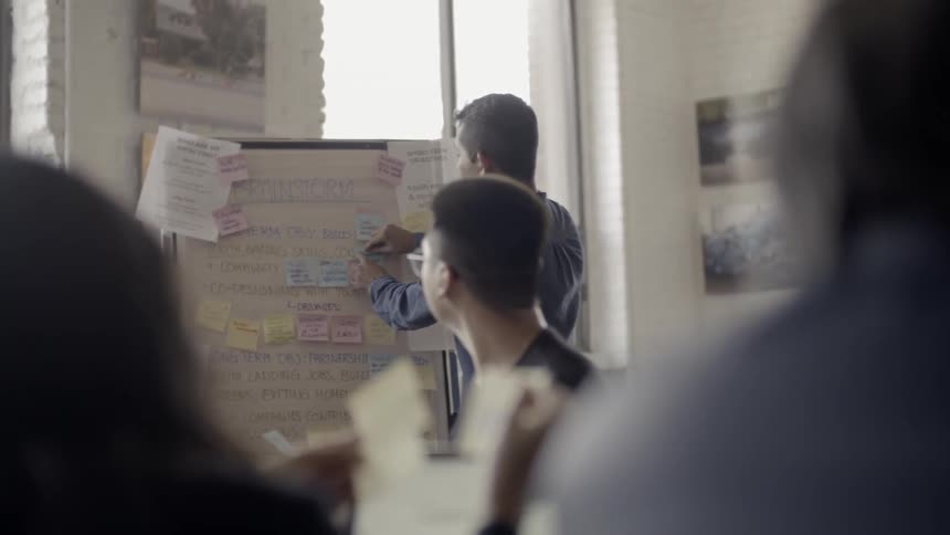 People are working in an office talking together