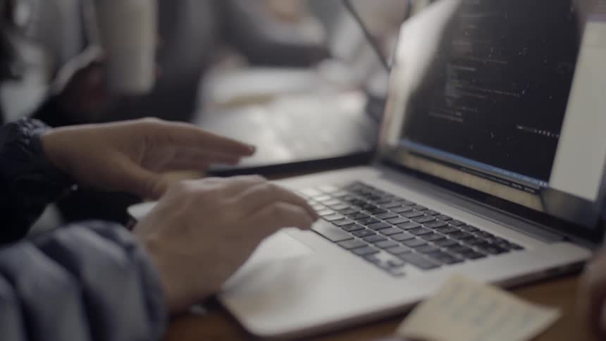 A person is typing on their laptop