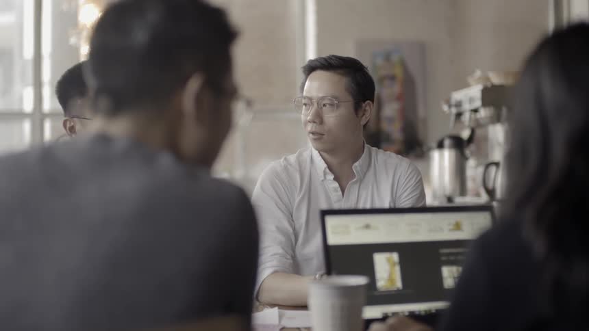 People sit around a table working in an office