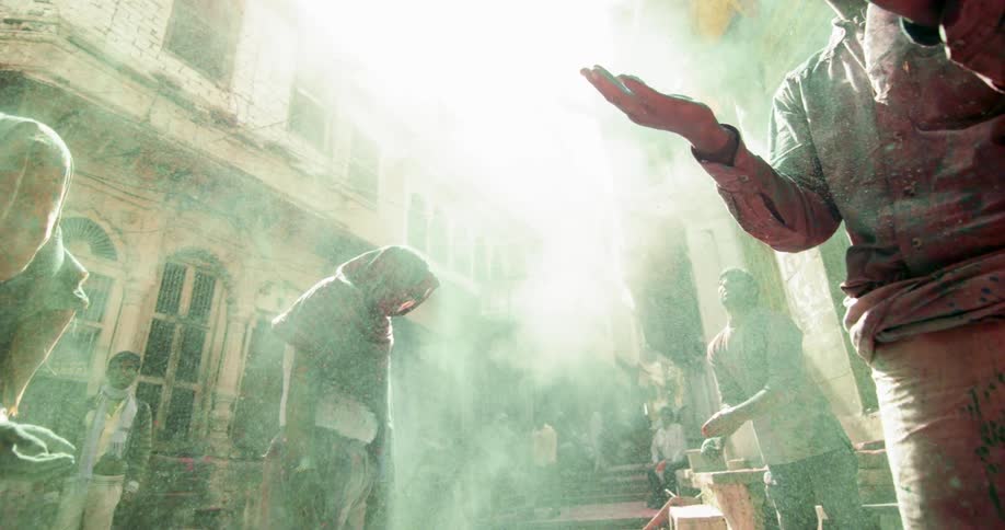 People stand outside as chalk powder rains down on them