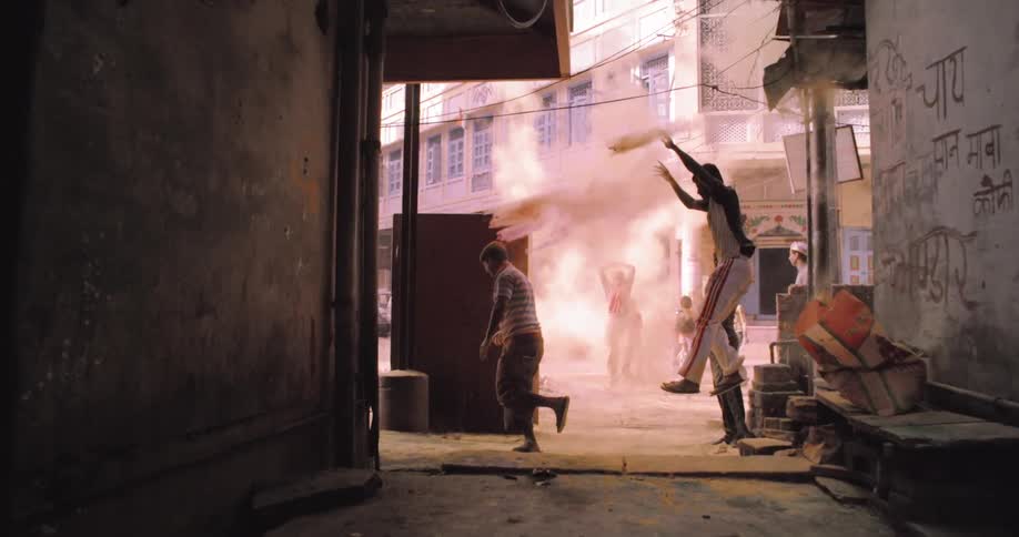 A man throws dirt in an alley