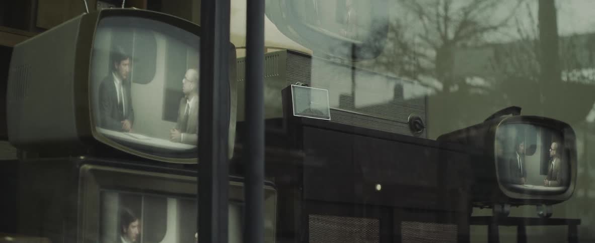 A tv program showing in a store window