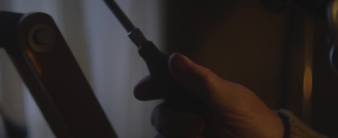 Man using a tool in a dark room