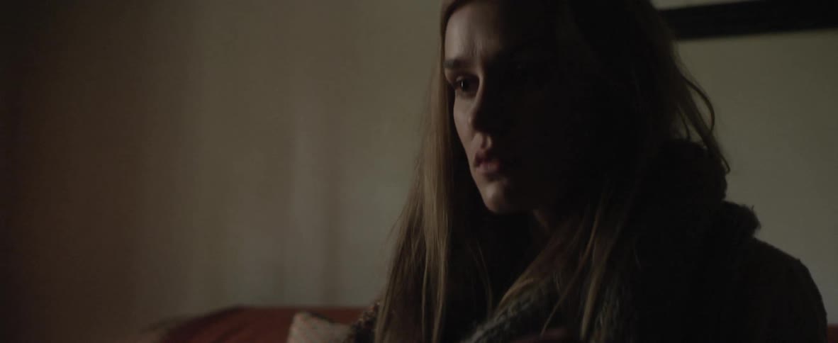 Woman sits and looks around concerned
