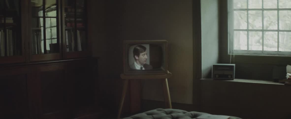 Small television playing in the corner of a room