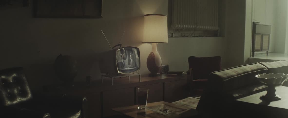 Living room with a television playing a program