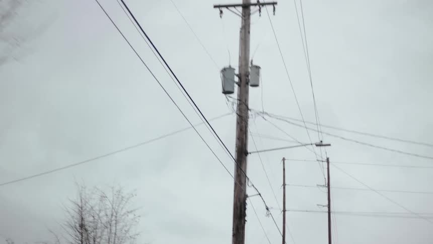 Power lines hang above the road near buildings