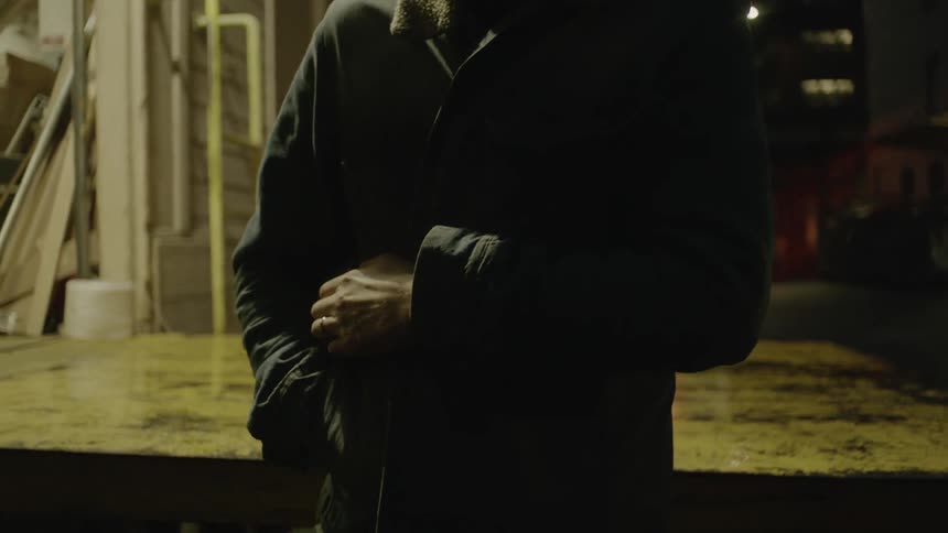 A man closes his jacket outside