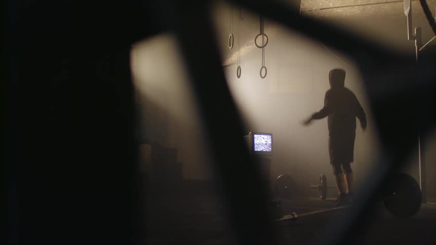 A man jumps rope in a gym
