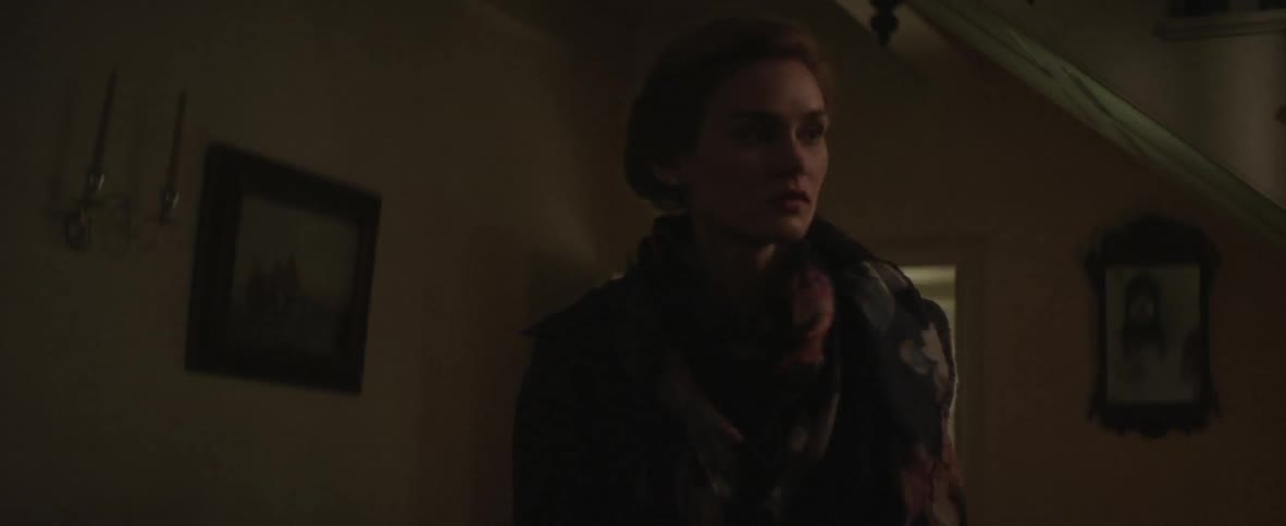 A woman enters her home