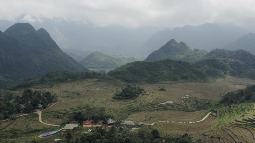 Clouds hang above the mountains and valley
