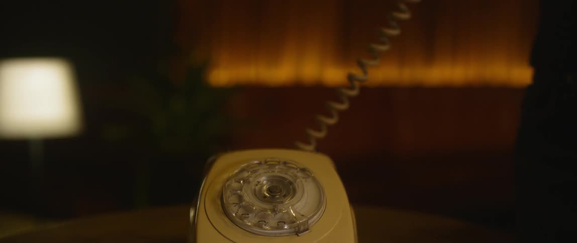 Person picks up the handset on rotary phone