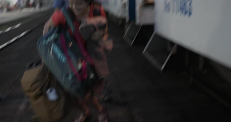 A woman exits a train