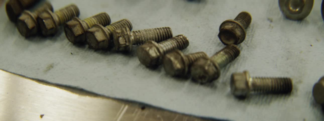 Dirty bolts sit on a table