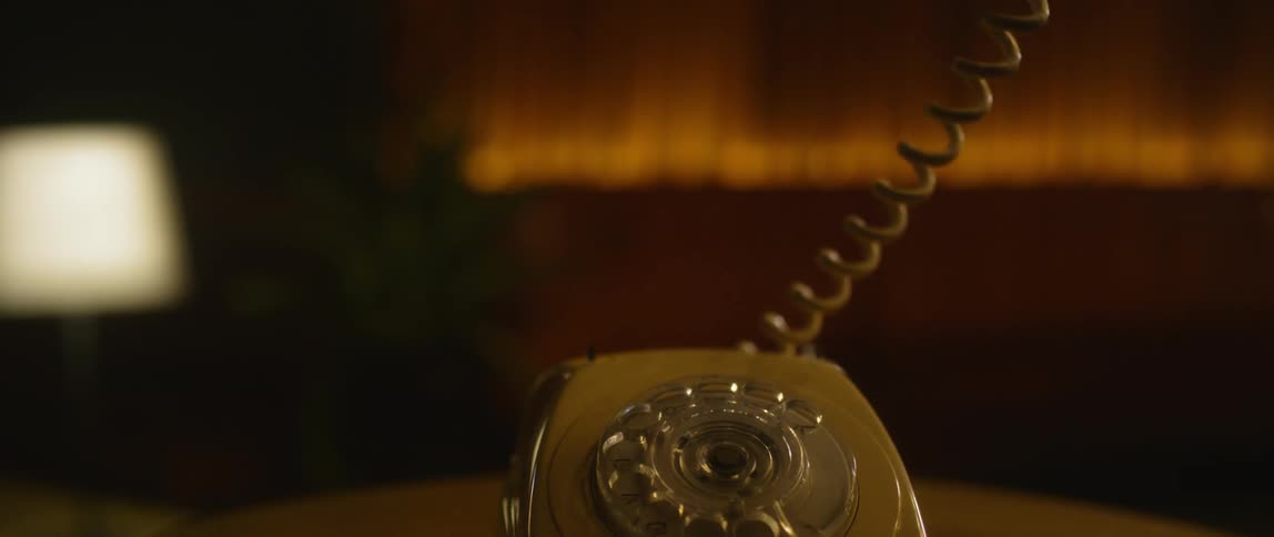 Person picks up a telephone receiver and hangs up