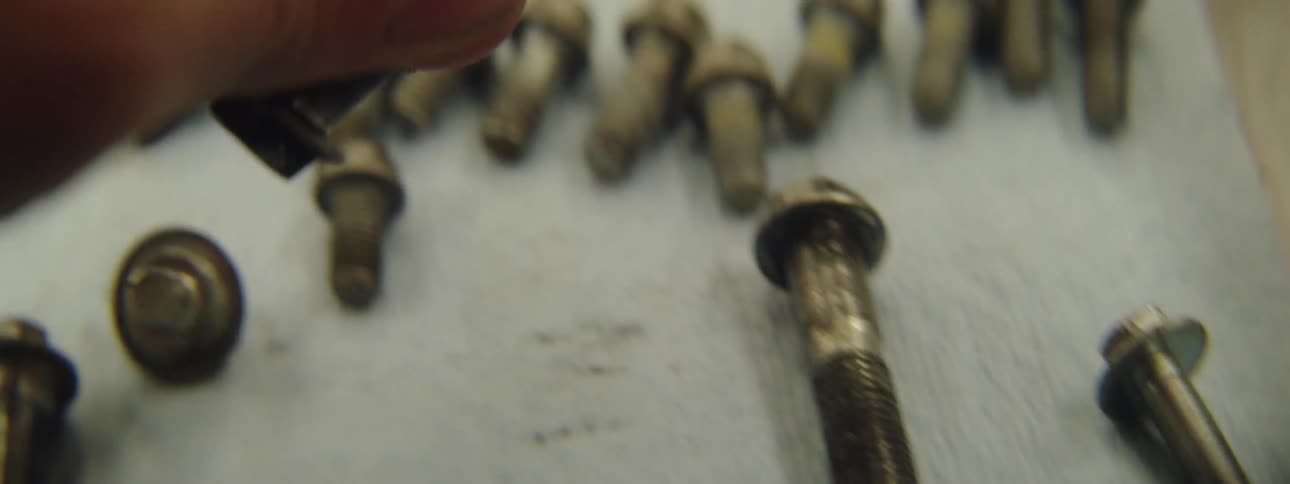A man grabs a bolt