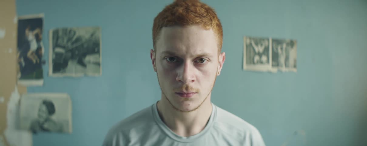 Man looks angry while sitting indoors