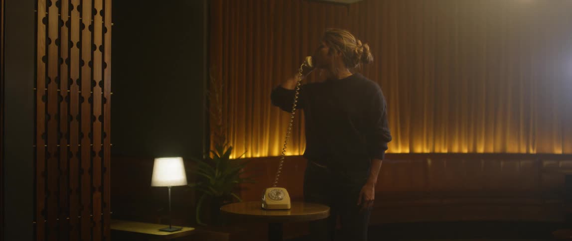 The woman is talking on the telephone