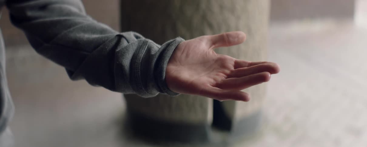 Water drips onto an outreached hand