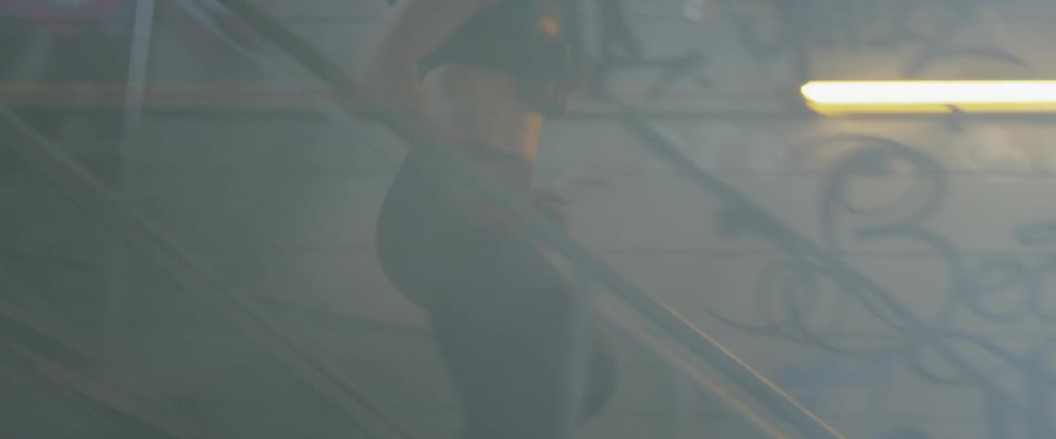 Woman runs down a flight of stairs