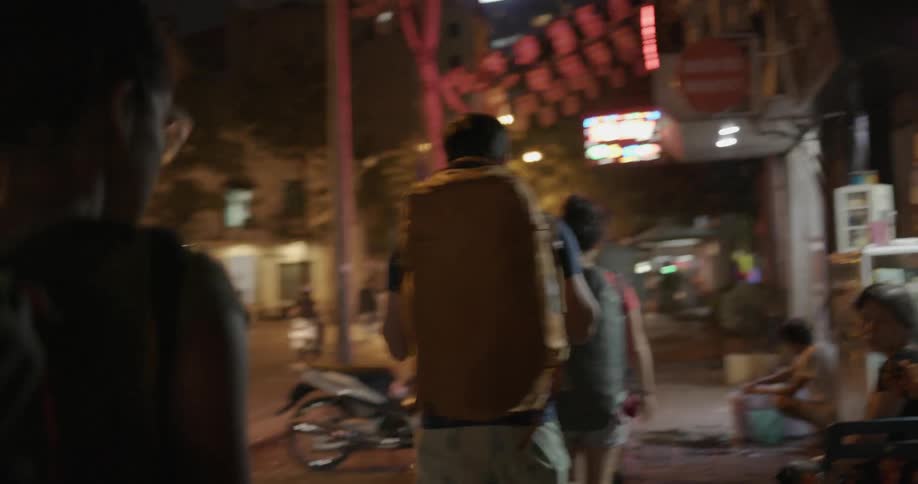 Pedestrians walk on a city sidewalk