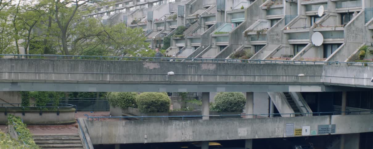 Man runs across a city bridge