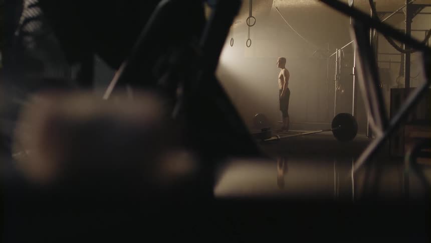 A man stands inside a gym