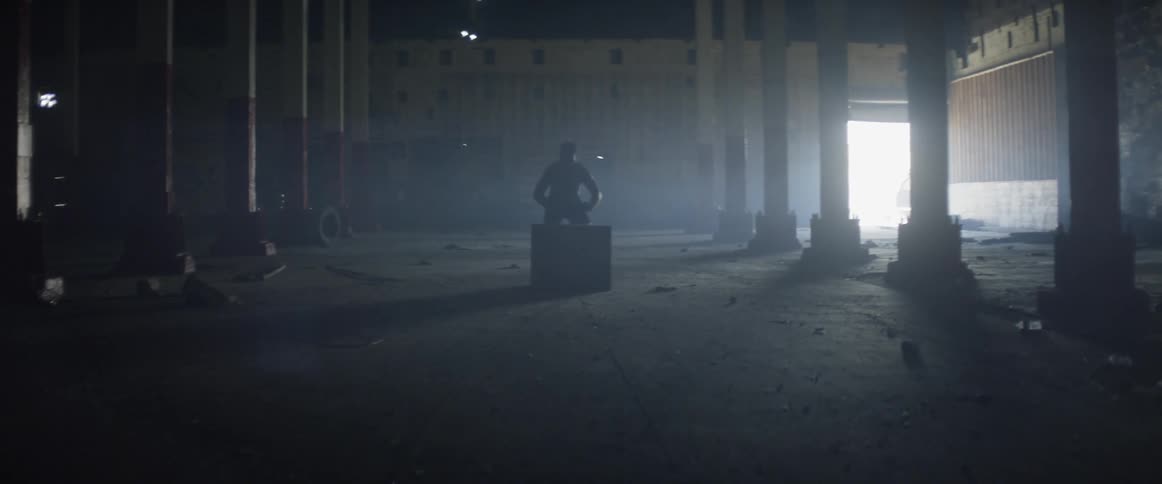 A man jumps up and down on a block in the hall