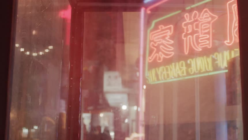 Outside of the shop window is a busy city street