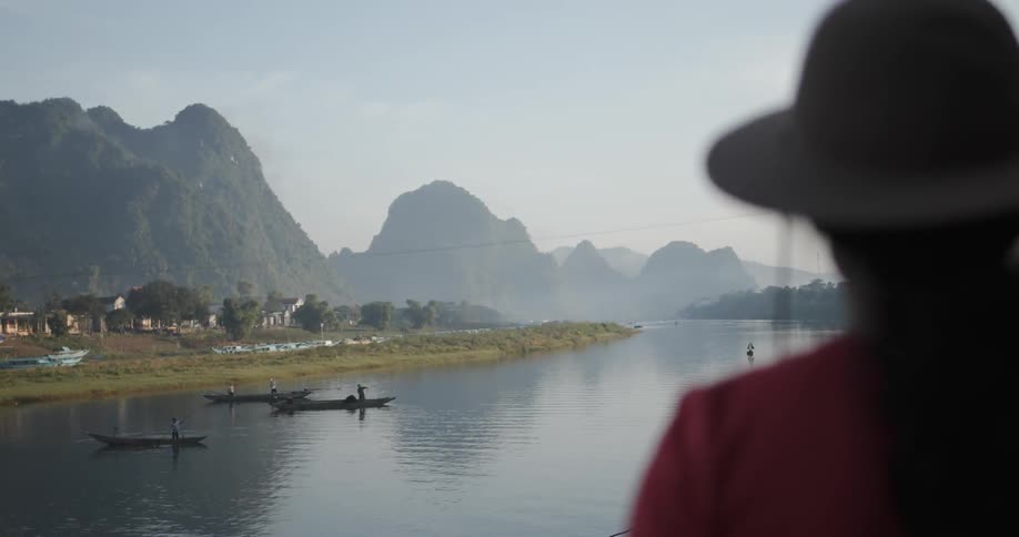 Woman watches boats on a lake