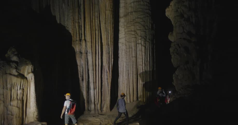 A group of people enter the cave together