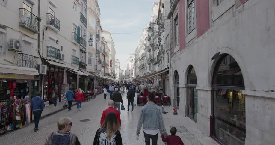 Pedestrians walk down the city street