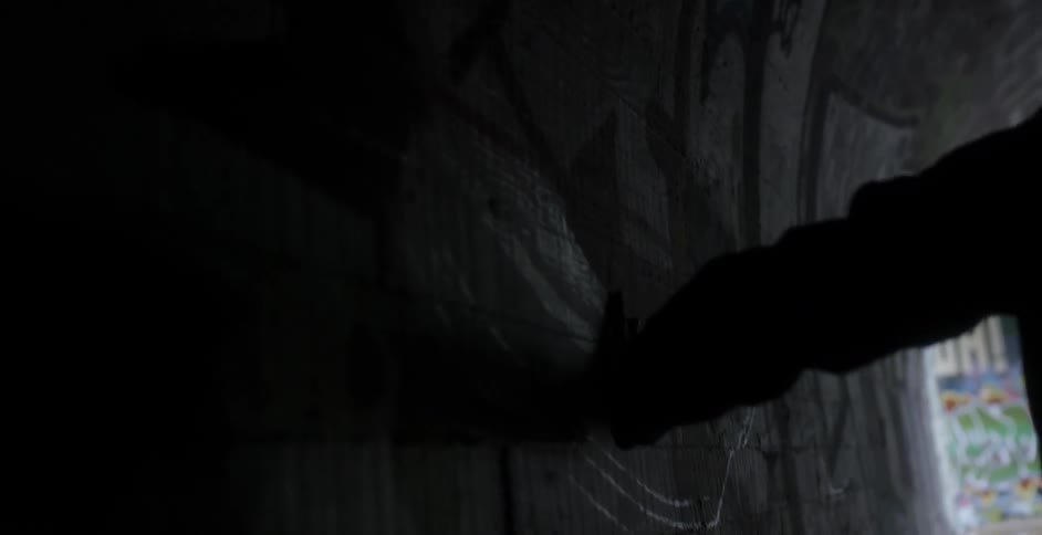 Person walks through a tunnel touching the walls