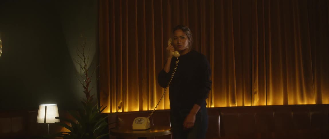 A woman is talking on the telephone