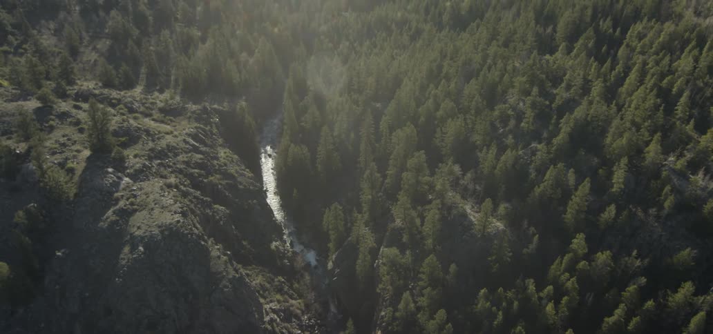 A river flows at the foot of the hills