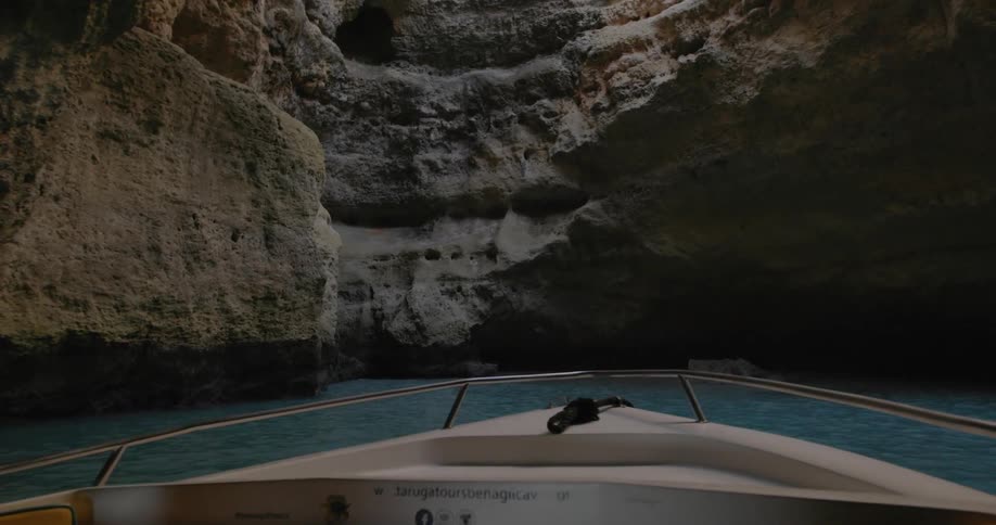 Boat travels through the water near the rocks