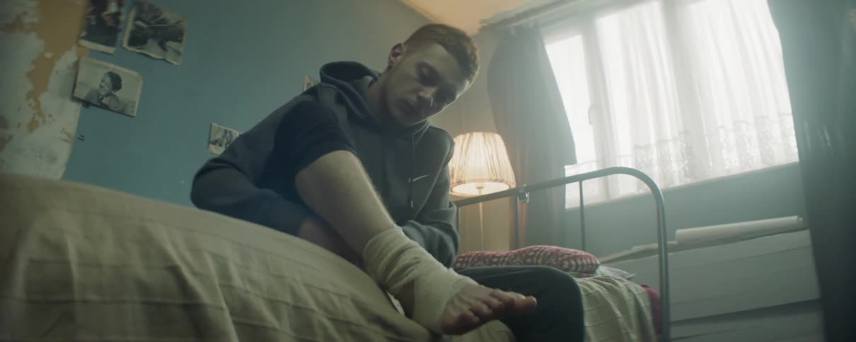 Man wraps his foot and ankle in a bandage