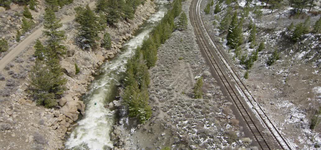 River is flowing next to railroad tracks