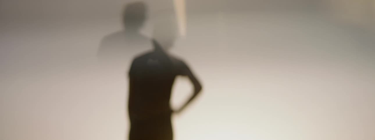 The silhouette of a person putting their hand on their hip