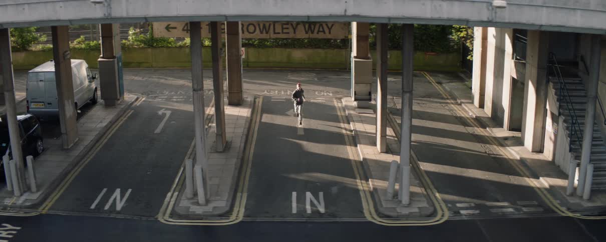 A man jogs down the road below