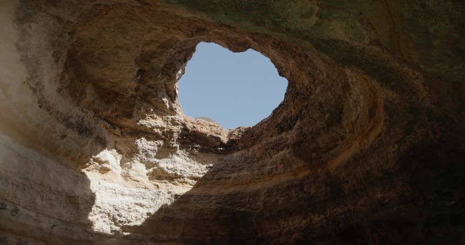 Sun shines through an opening in the cave