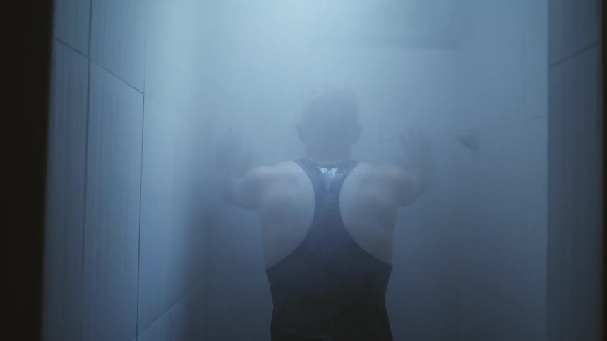 A man stands inside a shower