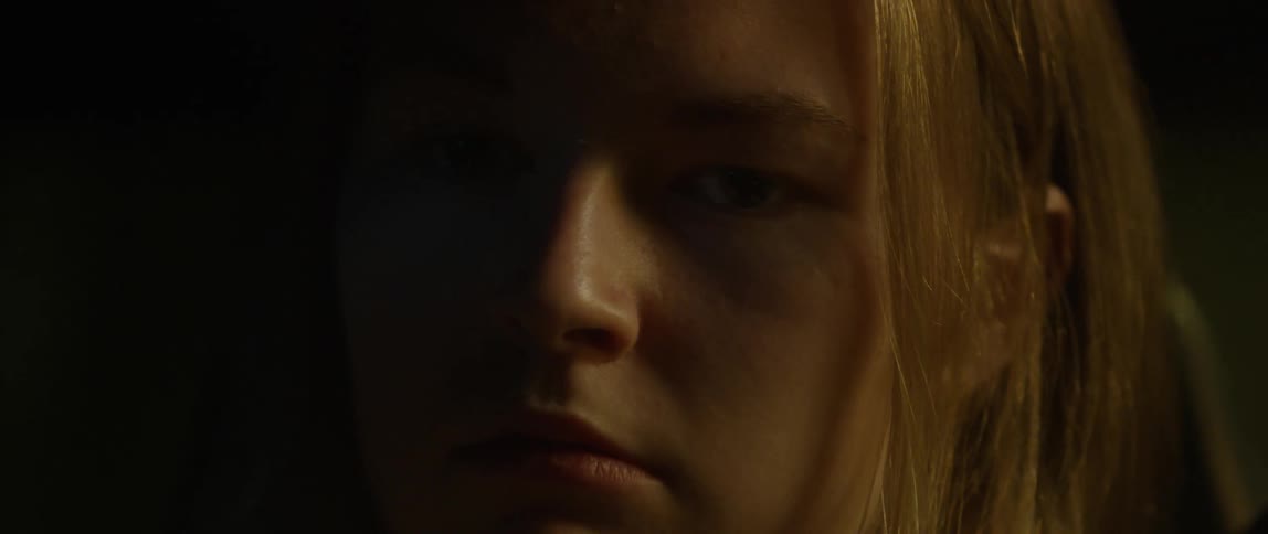 Woman sits in the dark
