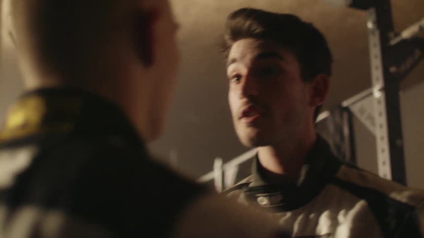 A man grabs someone and argues with him