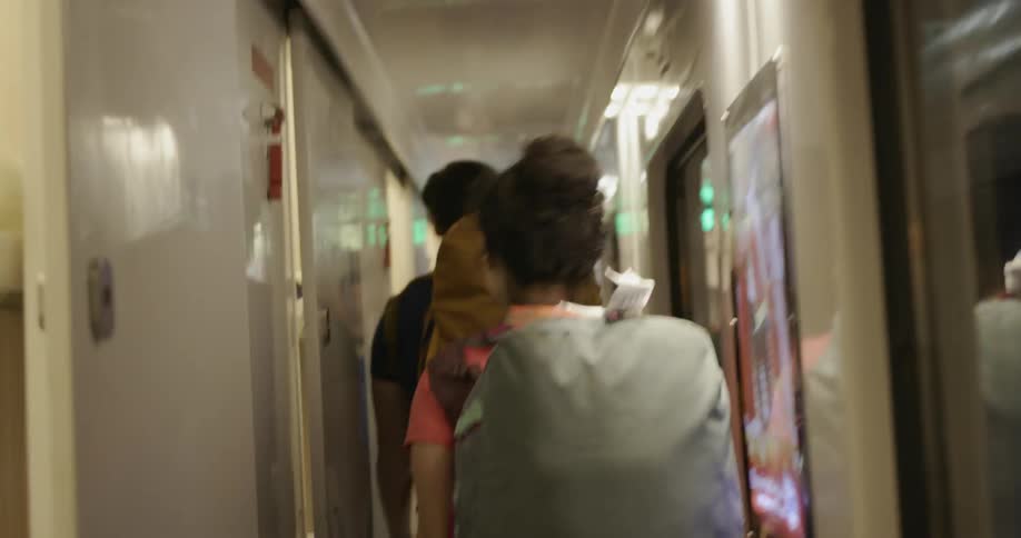 Man and woman walk on a train