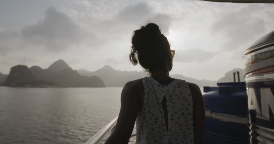 A woman walks on a boat deck