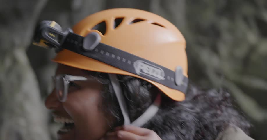 Woman smiles and fastens her helmet