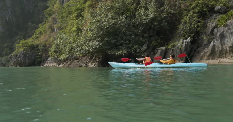 Two women paddle in a kayak